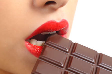 Beautiful woman red lips eating chocolate isolated on a white background             の写真素材