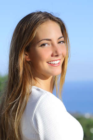 Portrait of a beautiful woman with a white perfect smile outdoor             の写真素材