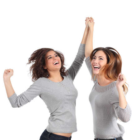 Two euphoric girls jumping isolated on a white background              の写真素材