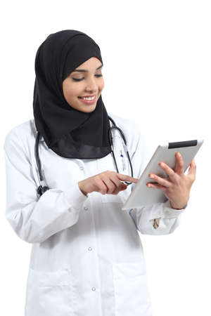 Saudi arab doctor woman working with a tablet isolated on a white background               の写真素材