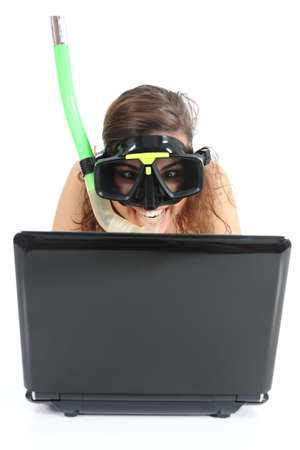 Snorkel woman websurfing in a netbook computer isolated on a white backgroundの写真素材