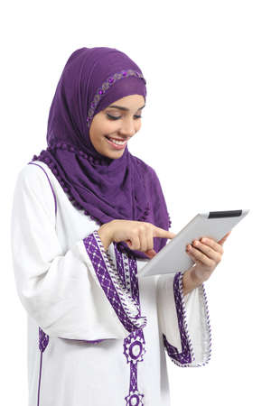 Arab woman reading and touching a tablet reader isolated on a white background         の写真素材