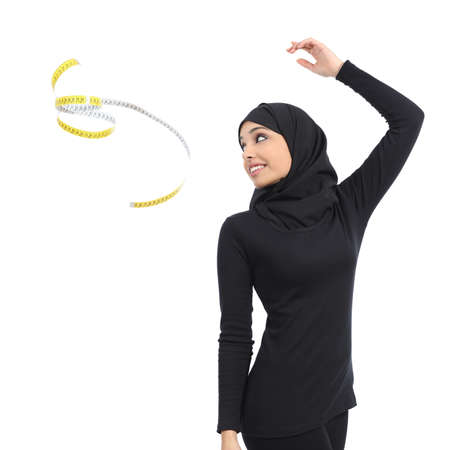 Arab saudi fitness woman throwing a measure tape isolated on a white background               の写真素材