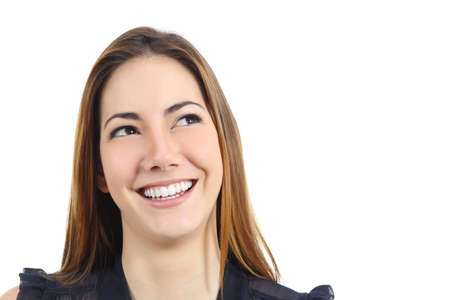 Portrait of a happy woman with perfect white smile looking sideways isolated on a white backgroundの写真素材