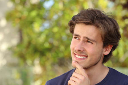 Happy man thinking outdoorの写真素材
