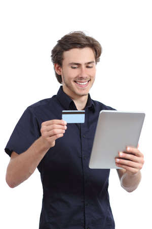 Happy man shopping with a credit card in a tablet isolated on a white background               の写真素材