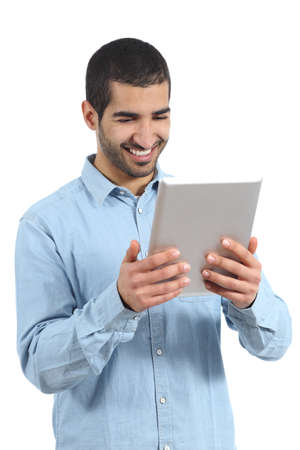 Arab happy casual man holding and reading a tablet reader isolated on a white backgroundの写真素材