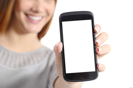 Close up of a funny woman holding a blank smart phone screen isolated on a white background           の写真素材