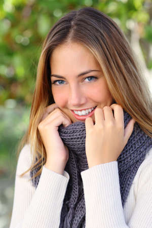 Beautiful woman with a white perfect smile and blue eyes in winter warmly clothed               の写真素材