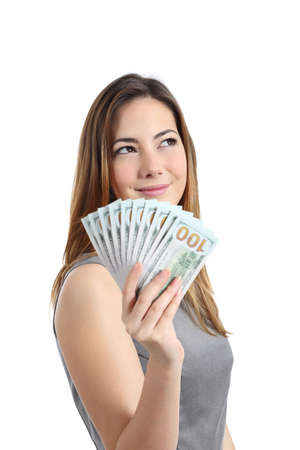 Business woman thinking and holding money isolated on a white の写真素材