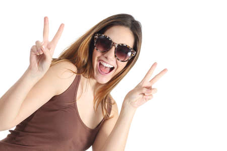 Funny casual teenager girl wearing fashion sunglasses gesturing victory isolated on a white background                  の写真素材