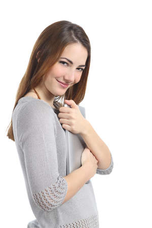 Pretty possessive woman hugging a tablet isolated on a white backgroundの写真素材