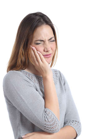 Woman suffering toothache with hand on face isolated on a white background             の写真素材