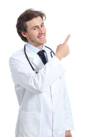 Doctor man presenting an advice pointing at side isolated on a white の写真素材