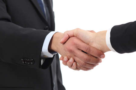 Closeup of a businessman and woman hands handshaking isolated on a white backgroundの写真素材