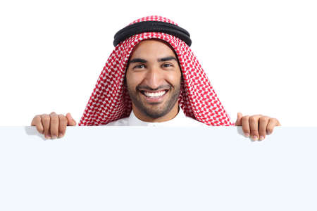 Arab happy saudi man displaying a banner sign isolated on a white backgroundの写真素材