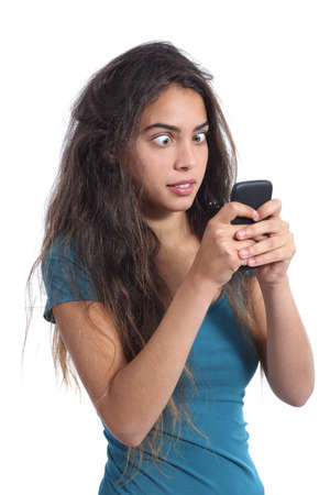 Obsessed crazy teenager girl with the mobile phone technology isolated on a white backgroundの写真素材