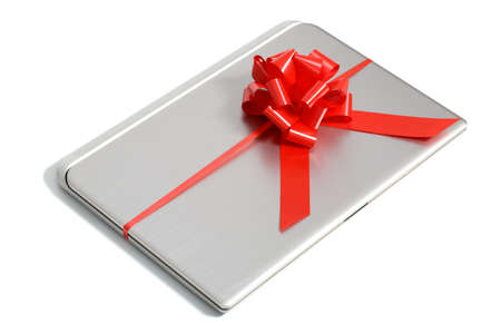 a laptop gift with a red ribbon isolated on a white backgroundの写真素材