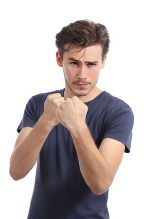 Casual young man ready to fight attacking with fist up isolated on a white backgroundの写真素材