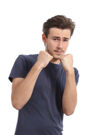 Casual young man ready to fight defending with fist up isolated on a white backgroundの写真素材