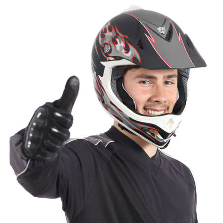 Happy motor biker man gesturing thumbs up isolated on a white backgroundの写真素材