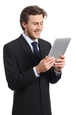 Happy young business man reading a tablet reader isolated on a white backgroundの写真素材