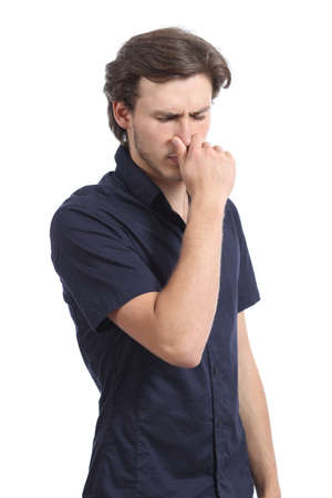 Man holding his nose smelling stink isolated on a white backgroundの写真素材