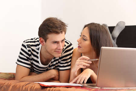 Students studying and learning at home with a laptop and notesの写真素材