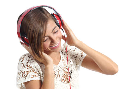 Candid happy woman feeling the music from red headphones isolated on a white backgroundの写真素材
