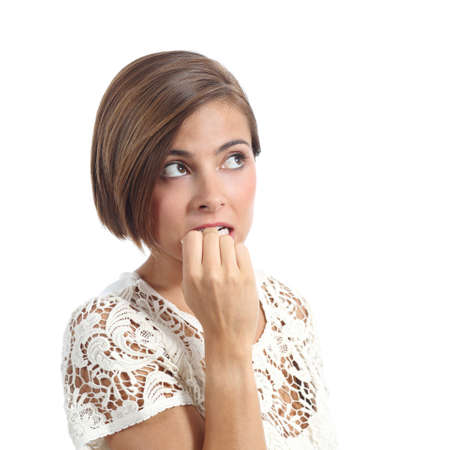 Nervous pensive woman biting nails isolated on a white backgroundの写真素材