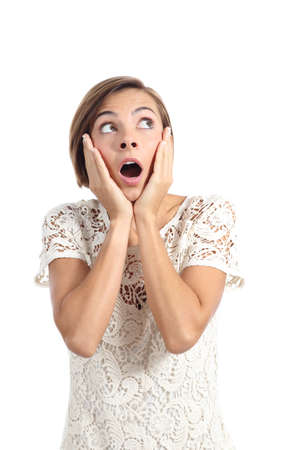 Shocked woman looking at side with hands on face isolated on a white backgroundの写真素材