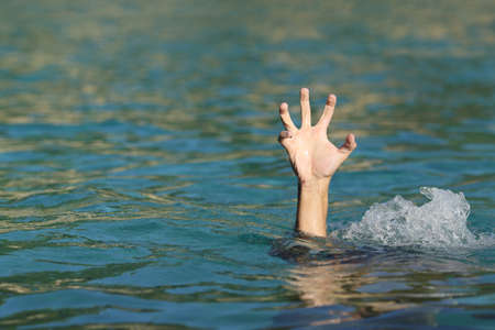 Hand of a man drowning in the sea trying to floatの写真素材
