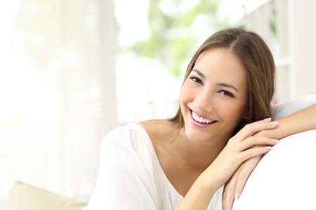 Beauty woman with white perfect smile looking at camera at home