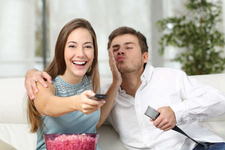 Woman prefers tv instead sex while her husband is trying to seduce herの写真素材