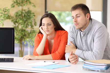 Two bored customers waiting for attendance at office