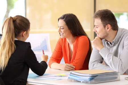 Happy businesspeople talking about earnings during an audit at officeの写真素材