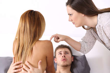 Cheater having sex with his lover caught in act by an angry wife in an humorous situationの写真素材