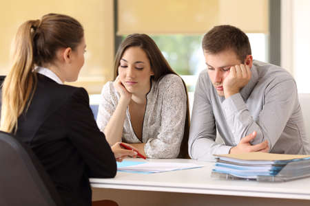 Bad saleswoman trying to convince to an unconvinced customers at office