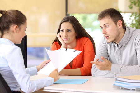Sad couple with problems talking in a marriage counselingの写真素材