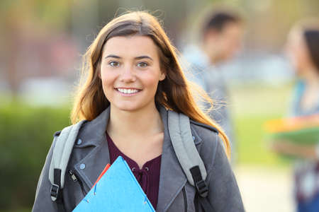 One happy student posing looking at you in an university campusの写真素材