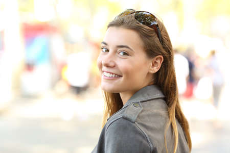 Portrait of a beautiful girl looking at camera on the streetの写真素材