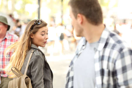 Sassy girl looking at a hot man bottom on the streetの写真素材