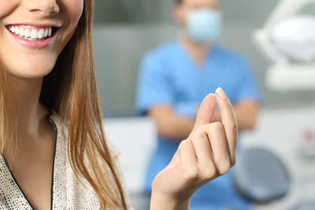 Close up of a dentist patient hand holding a blank productの写真素材