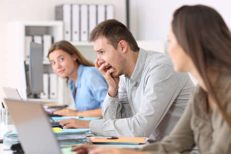 Side view portrait of a scared employee after a big mistake on line at officeの写真素材