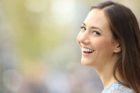 Portrait of a beautiful woman smiling to camera on the street with copy spaceの写真素材