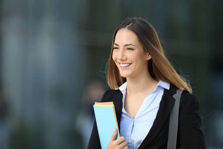 Portrait of a happy executive smiling and walking on the streetの写真素材