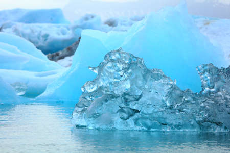 Detail of a little blue iceberg floating on the sea