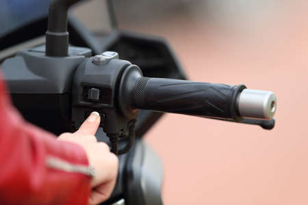 Close up of a motorbiker hand starting engine of a motorbikeの写真素材
