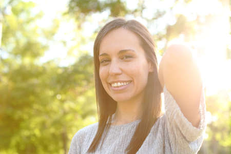 Portrait of a beauty adult woman posing looking at camera in a parkの写真素材