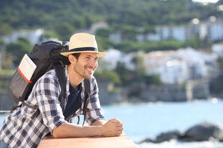 Happy tourist sightseeing from a balcony traveling on summer vacationの写真素材